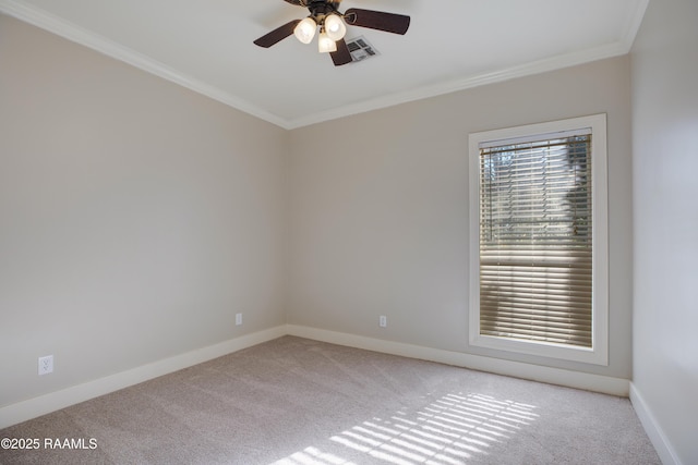 spare room with ceiling fan, light colored carpet, and crown molding