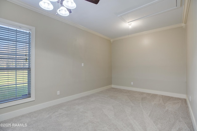 spare room featuring light carpet, ceiling fan, and ornamental molding