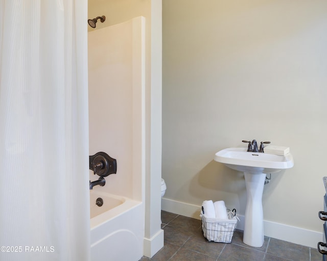 bathroom featuring bathing tub / shower combination and toilet