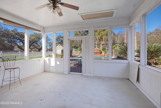 unfurnished sunroom featuring ceiling fan