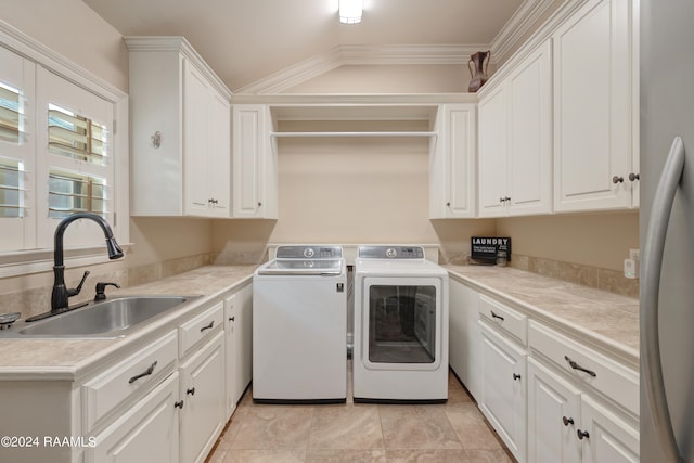 laundry room featuring independent washer and dryer, sink, light tile patterned flooring, crown molding, and cabinets