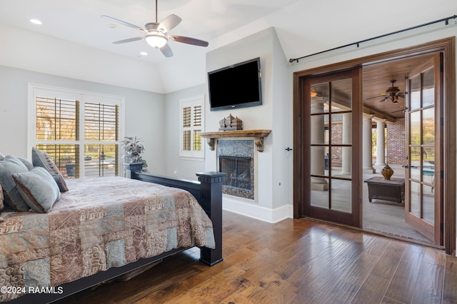 bedroom with ceiling fan, vaulted ceiling, and dark hardwood / wood-style flooring