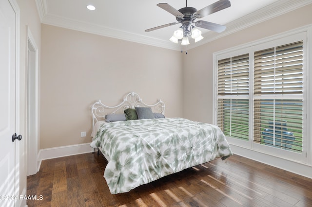 bedroom with dark wood-type flooring, crown molding, and ceiling fan