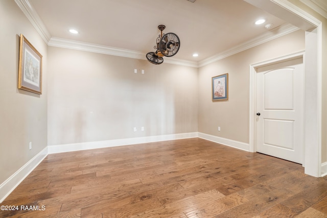 empty room featuring ornamental molding and hardwood / wood-style flooring