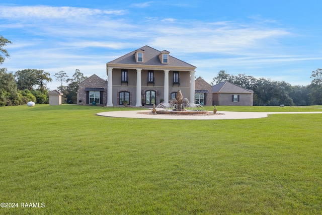 greek revival house featuring a front yard and a porch