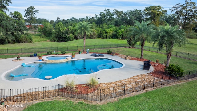 view of pool with an in ground hot tub, a yard, and a patio area