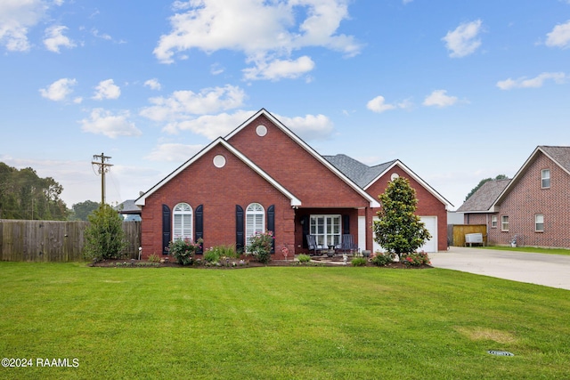 view of front of house with a garage and a front lawn