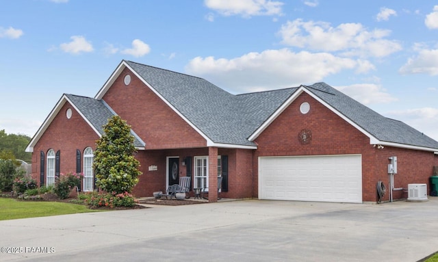 view of property featuring a garage and central air condition unit