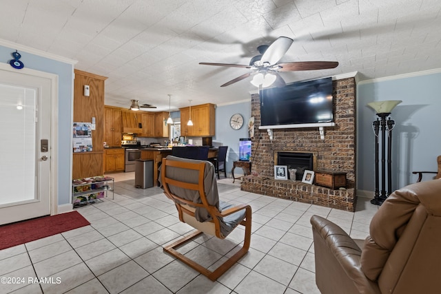 tiled living room featuring ceiling fan, a brick fireplace, and crown molding