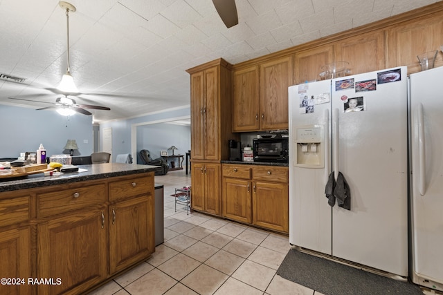 kitchen featuring ceiling fan, white refrigerator with ice dispenser, and light tile patterned flooring