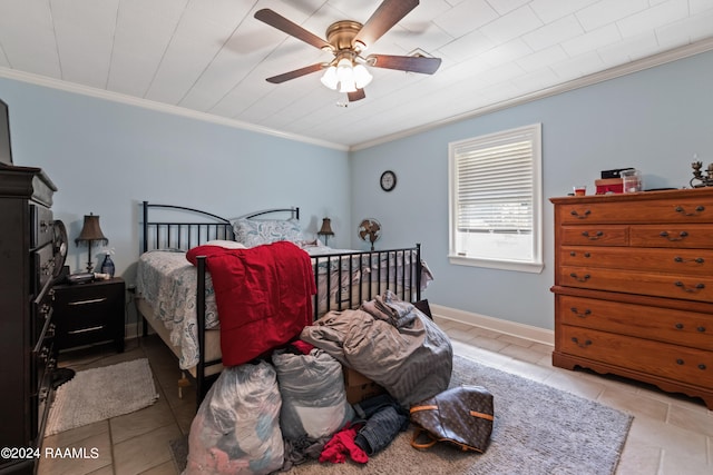 tiled bedroom with ornamental molding and ceiling fan