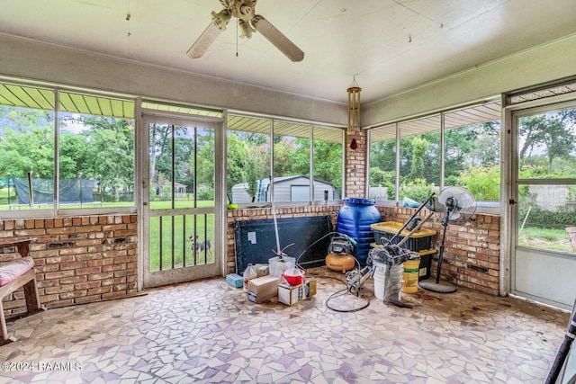 sunroom / solarium featuring ceiling fan and a healthy amount of sunlight