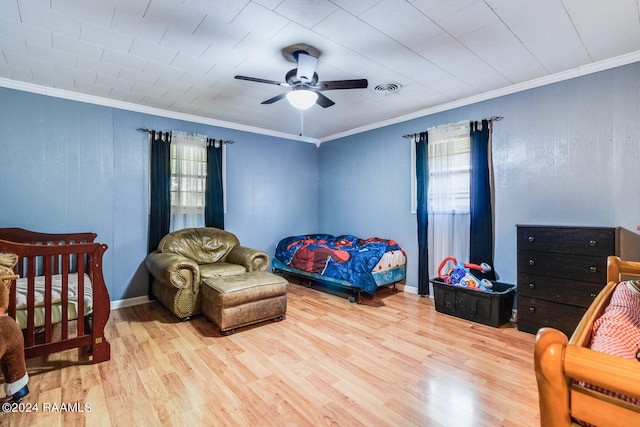 bedroom with light wood-type flooring, crown molding, ceiling fan, and multiple windows