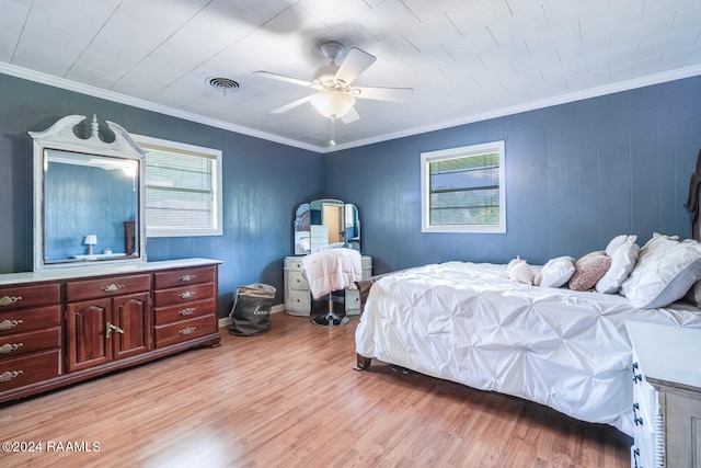 bedroom with ceiling fan, ornamental molding, and light hardwood / wood-style floors