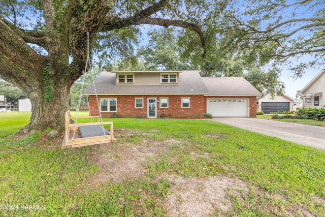 view of front of house with a garage and a front lawn