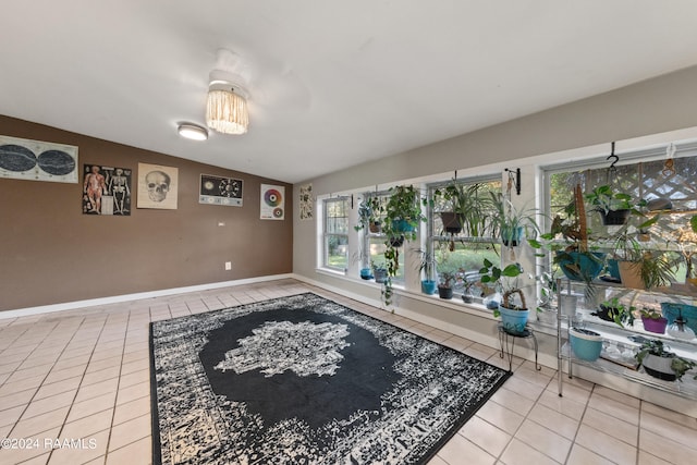 sitting room with lofted ceiling and tile patterned floors