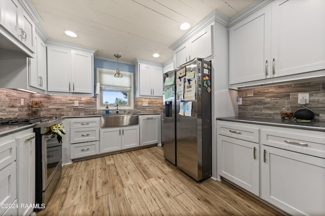 kitchen featuring light hardwood / wood-style flooring, white cabinets, and appliances with stainless steel finishes