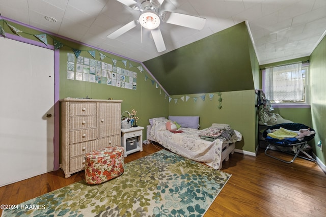 bedroom with ceiling fan, hardwood / wood-style flooring, and lofted ceiling