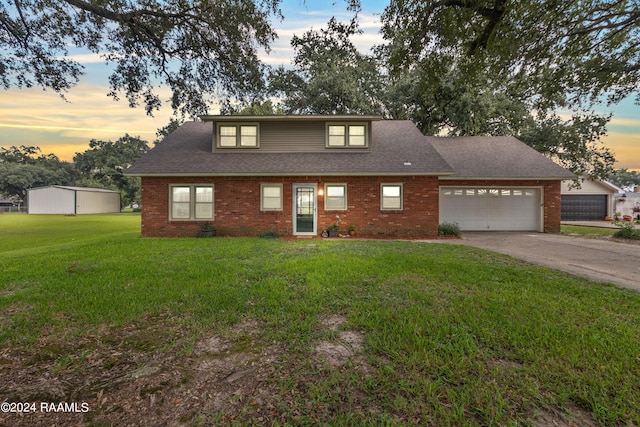 view of front of property featuring a garage and a yard