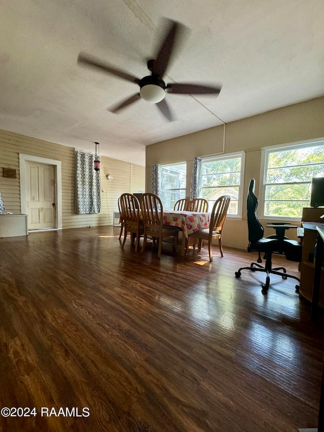 dining space with a textured ceiling, dark wood-type flooring, and ceiling fan