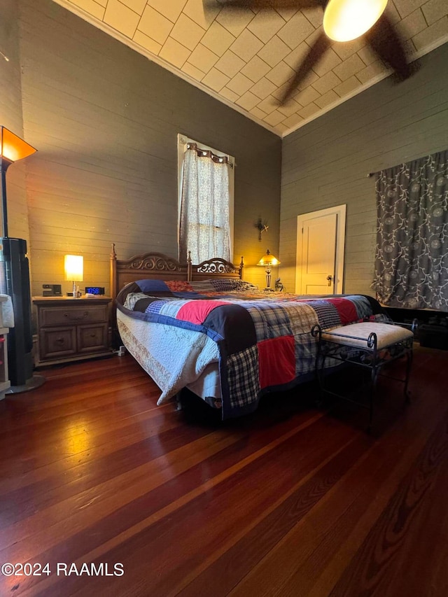 bedroom with dark hardwood / wood-style flooring