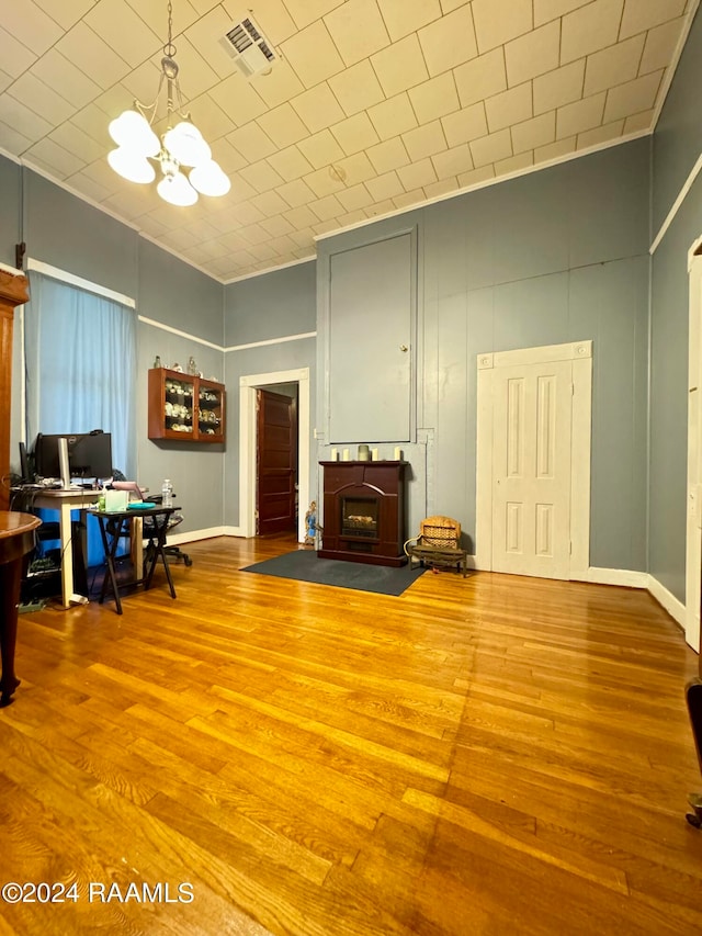 miscellaneous room featuring a chandelier and hardwood / wood-style floors