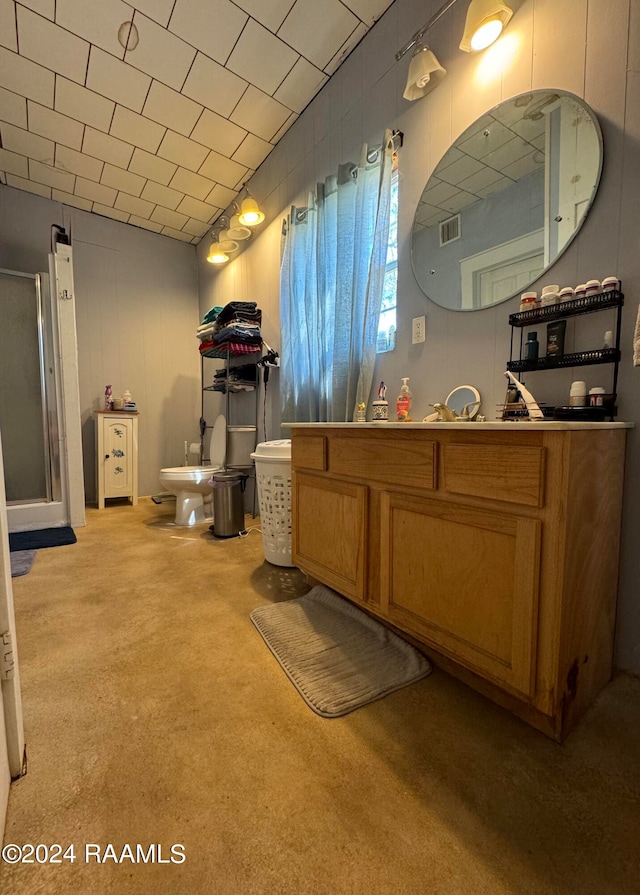 bathroom featuring a bidet, vanity, a shower with shower door, and toilet