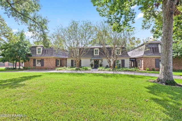 201 Canterbury Rd, Lafayette, LA 70508 - front facade featuring mansard roof, a front yard, a shingled roof, and brick siding