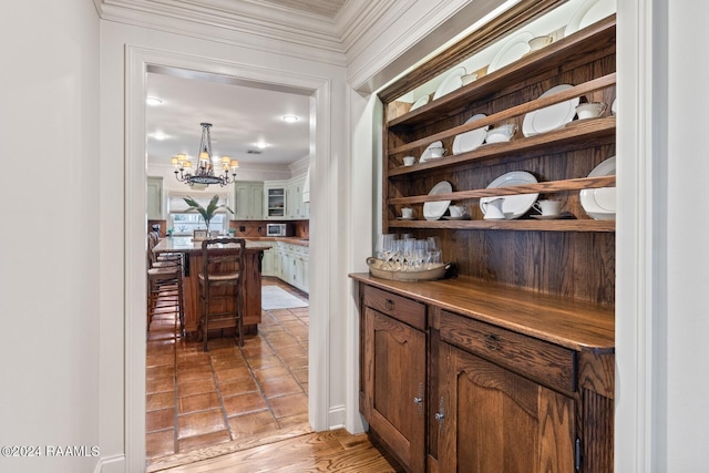 201 Canterbury Rd, Lafayette, LA 70508 - bar featuring ornamental molding and a chandelier