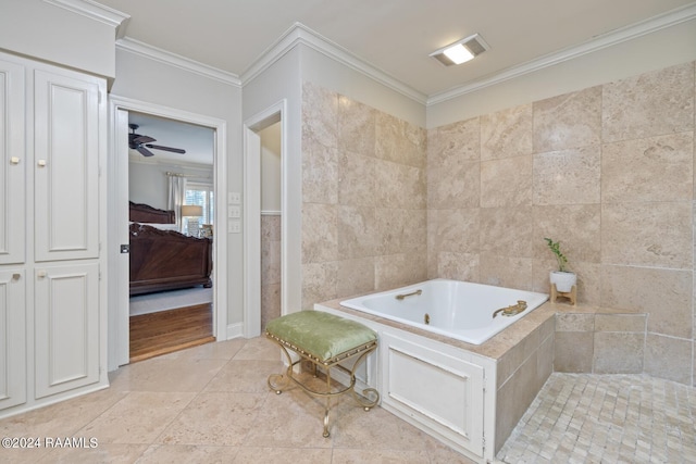 bathroom with tile walls, tile patterned flooring, tiled tub, crown molding, and ceiling fan