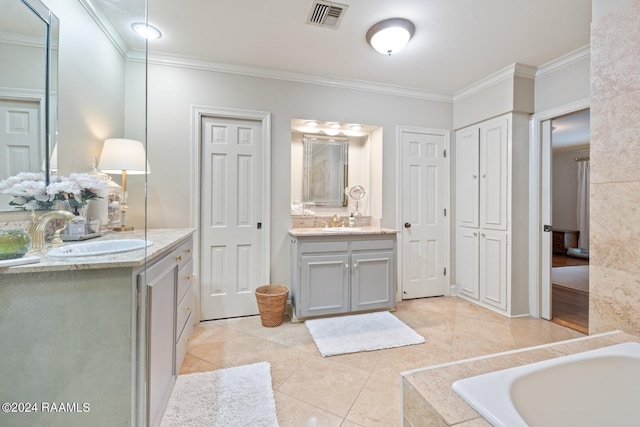 bathroom featuring ornamental molding, tile patterned flooring, tiled tub, and vanity