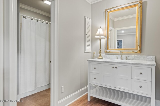 bathroom with wood-type flooring, curtained shower, vanity, and crown molding