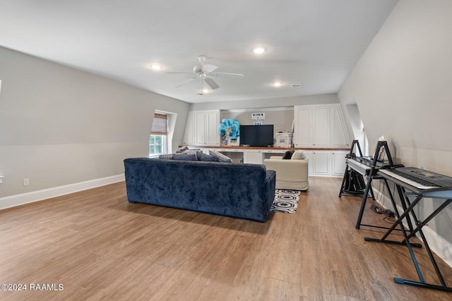 living room featuring ceiling fan and light hardwood / wood-style flooring