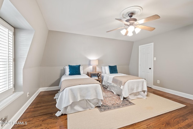 bedroom featuring ceiling fan, lofted ceiling, and dark wood-type flooring