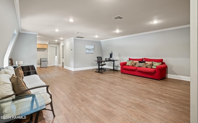 sitting room featuring crown molding and light hardwood / wood-style flooring