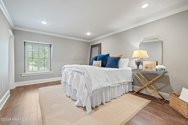 bedroom with hardwood / wood-style flooring and crown molding