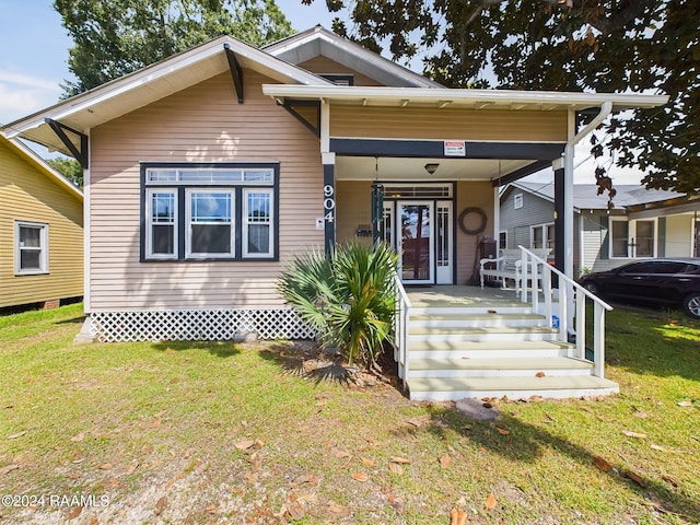 view of front of home with a front lawn and covered porch