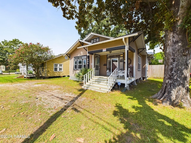 bungalow featuring a front lawn and a porch