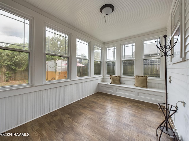 unfurnished sunroom featuring plenty of natural light and a chandelier