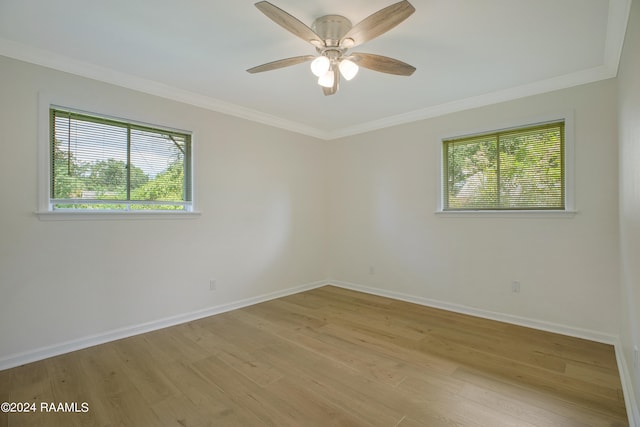 empty room featuring ceiling fan, ornamental molding, and light hardwood / wood-style floors