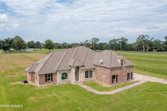 view of front of property with a front yard and cooling unit