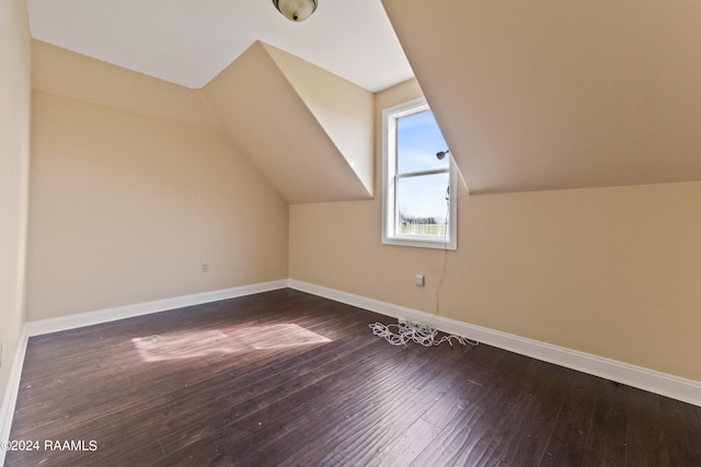 bonus room with lofted ceiling and dark hardwood / wood-style flooring