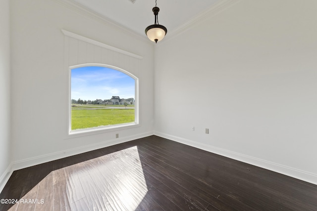 empty room with ornamental molding and dark hardwood / wood-style flooring