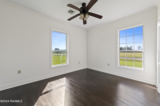 unfurnished room featuring crown molding, dark hardwood / wood-style floors, and a wealth of natural light