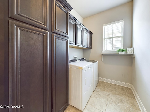 clothes washing area featuring cabinets, independent washer and dryer, and light tile patterned floors