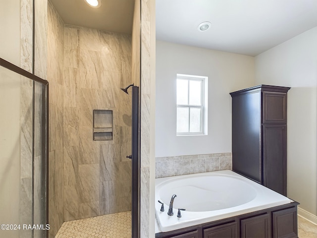 bathroom with separate shower and tub