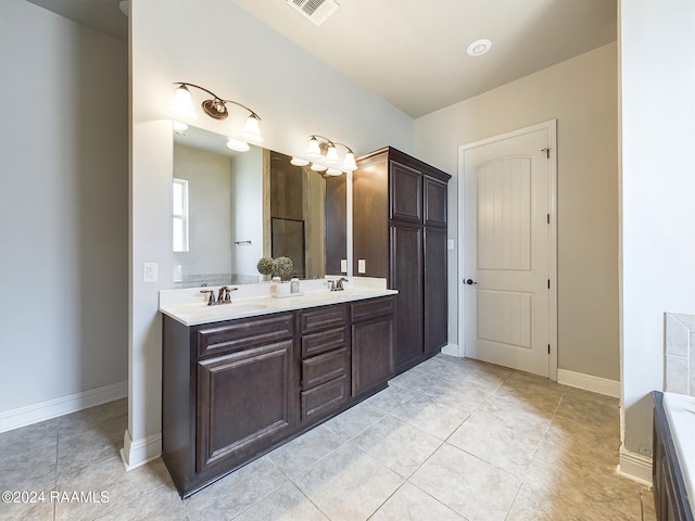 bathroom with tile patterned floors and vanity