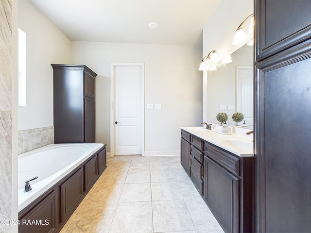 bathroom with tile patterned flooring, vanity, and a bathtub