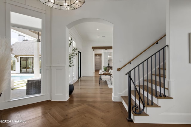 foyer entrance with dark parquet flooring