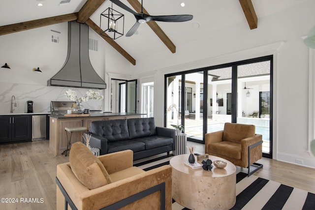 living room featuring sink, light hardwood / wood-style flooring, beam ceiling, and high vaulted ceiling